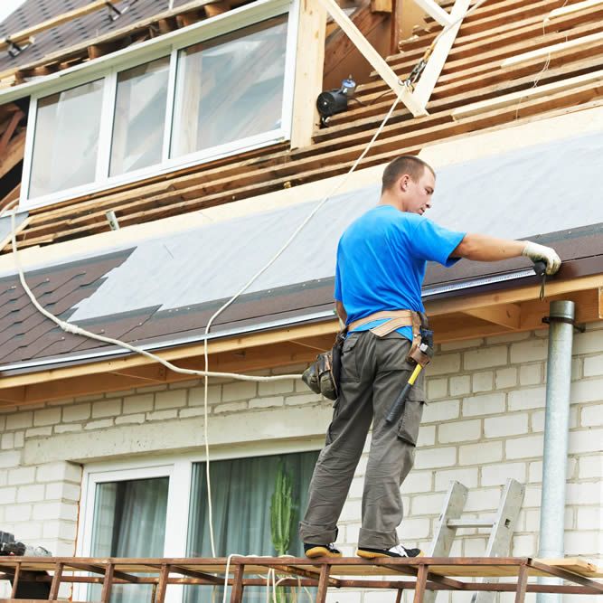IC Roofing installer tied off for safety